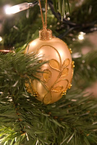 Pretty egg-shaped ornament hanging on a (fake) Christmas tree