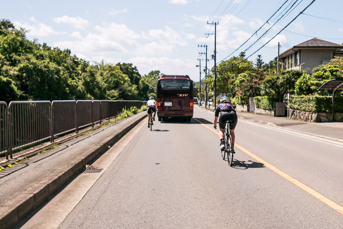 Lumbering Bus Blocking Our Path taken while cycling at 53 kph (33 mph) -- Kyoto, Japan -- Copyright 2015 Jeffrey Friedl, http://regex.info/blog/