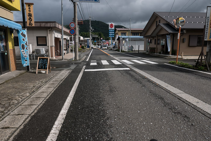 Kutsuki Village near the turnoff to the ski grounds mentioned in the previous post 9:37am - taken while cycling at 13 kph (8 mph) -- おみやげのカネハチ -- Takashima, Shiga, Japan -- Copyright 2016 Jeffrey Friedl, http://regex.info/blog/ -- This photo is licensed to the public under the Creative Commons Attribution-NonCommercial 4.0 International License http://creativecommons.org/licenses/by-nc/4.0/ (non-commercial use is freely allowed if proper attribution is given, including a link back to this page on http://regex.info/ when used online)