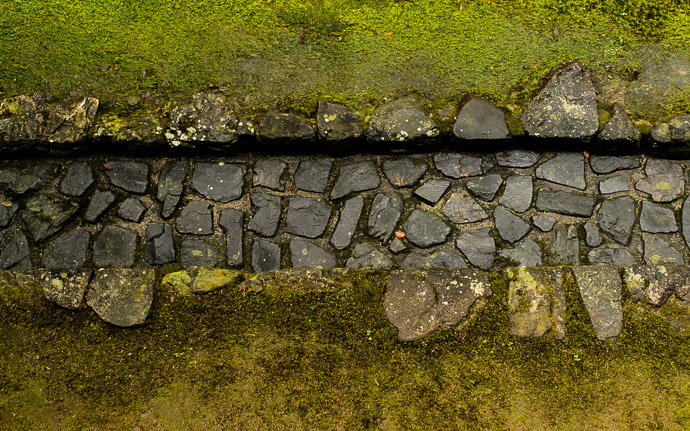 desktop background image of private garden at the Honen -- Unweathered I think the stones provide a sturdy area for roof runoff to hit the ground -- Honen'in Temple (法然院) -- Kyoto, Japan -- Copyright 2012 Jeffrey Friedl, http://regex.info/blog/ -- This photo is licensed to the public under the Creative Commons Attribution-NonCommercial 3.0 Unported License http://creativecommons.org/licenses/by-nc/3.0/ (non-commercial use is freely allowed if proper attribution is given, including a link back to this page on http://regex.info/ when used online)