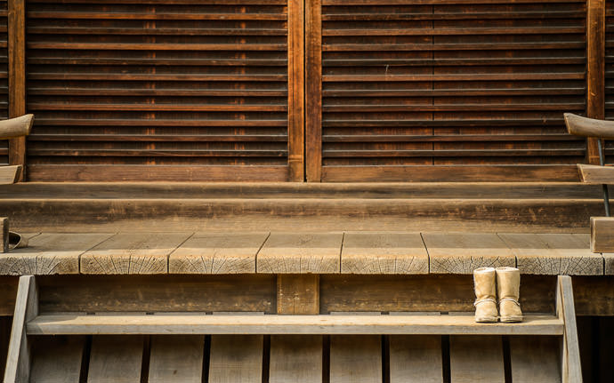 desktop background image of the steps to a side building at the Kitano Tenmangu Shrine (北野天満宮), Kyoto Japan, with a single pair of shoes indicating that one person is currently inside -- Current-Visitor Count: One at a minor side building -- Kitano Tenmangu Shrine (北野天満宮) -- Copyright 2013 Jeffrey Friedl, http://regex.info/blog/ -- This photo is licensed to the public under the Creative Commons Attribution-NonCommercial 4.0 International License http://creativecommons.org/licenses/by-nc/4.0/ (non-commercial use is freely allowed if proper attribution is given, including a link back to this page on http://regex.info/ when used online)