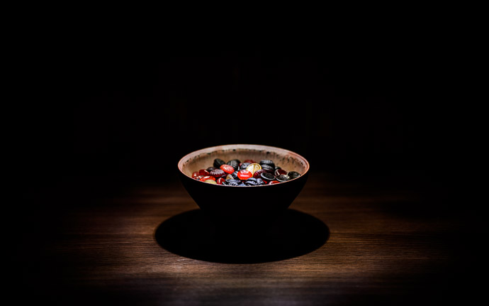 desktop background image of Läkerol candies in a tenmoku pottery bowl by Koji Kamada (鎌田幸二の天目と飴) -- Kyoto, Japan -- Copyright 2013 Jeffrey Friedl, http://regex.info/blog/ -- This photo is licensed to the public under the Creative Commons Attribution-NonCommercial 3.0 Unported License http://creativecommons.org/licenses/by-nc/3.0/ (non-commercial use is freely allowed if proper attribution is given, including a link back to this page on http://regex.info/ when used online)