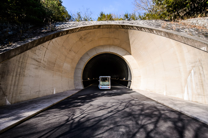 Tunnel Entrance and shuttle just passed -- Miho Museum (ミホミュージアム) -- Koka, Shiga, Japan -- Copyright 2013 Jeffrey Friedl, http://regex.info/blog/ -- This photo is licensed to the public under the Creative Commons Attribution-NonCommercial 3.0 Unported License http://creativecommons.org/licenses/by-nc/3.0/ (non-commercial use is freely allowed if proper attribution is given, including a link back to this page on http://regex.info/ when used online)