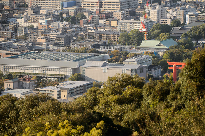 Okazaki Area of Kyoto from orange gate of the Heian Shrine, going left: municipal library, National Museum of Modern Art, Chamber of Commerce Exhibition Hall 京都岡崎、 平安神宮 の 大鳥 から左へは 図書館、 国立美術館、 みやこめっせ -- Shogunzuka (将軍塚) -- Kyoto, Japan -- Copyright 2014 Jeffrey Friedl, http://regex.info/blog/2014-12-28/2503 -- This photo is licensed to the public under the Creative Commons Attribution-NonCommercial 4.0 International License http://creativecommons.org/licenses/by-nc/4.0/ (non-commercial use is freely allowed if proper attribution is given, including a link back to this page on http://regex.info/ when used online)