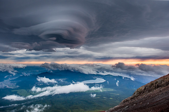 Sunrise from Mt. Fuji just prior to a storm -- Hakuunso on Mt. Fuji (富士山の白雲荘) -- Fujiyoshida, Yamanashi, Japan -- Copyright 2018 Jeffrey Friedl, http://regex.info/blog/ -- This photo is licensed to the public under the Creative Commons Attribution-NonCommercial 4.0 International License http://creativecommons.org/licenses/by-nc/4.0/ (non-commercial use is freely allowed if proper attribution is given, including a link back to this page on http://regex.info/ when used online)