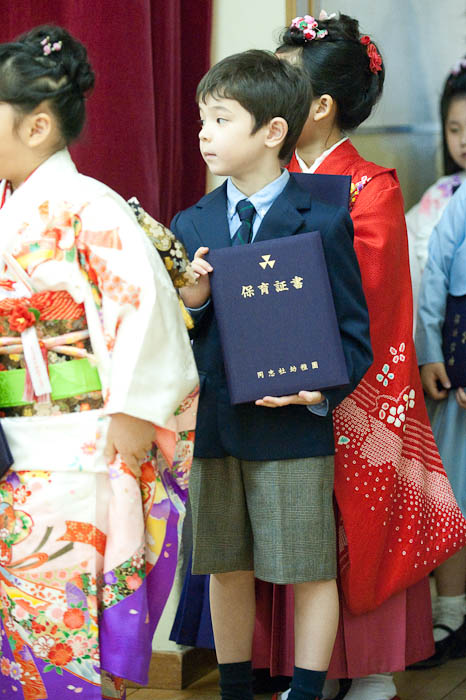 Returning for a Group Photo I caught the diploma at just the right time as he was idly playing with it -- Kyoto, Japan -- Copyright 2009 Jeffrey Friedl, http://regex.info/blog/
