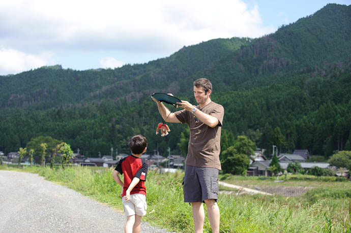 Hat Paragliding With a Stuffed Monkey like playing with your kid , some things have value way beyond money -- Kyoto, Japan -- Copyright 2009 Fumie, http://regex.info/blog/