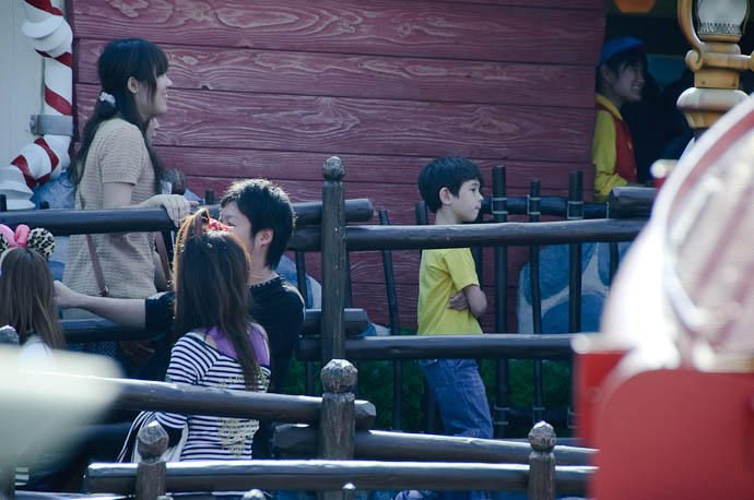 Waiting in Line apprehensive at riding by himself for the first time. -- Tokyo Disneyland -- Urayasu, Chiba, Japan -- Copyright 2009 Jeffrey Friedl, http://regex.info/blog/