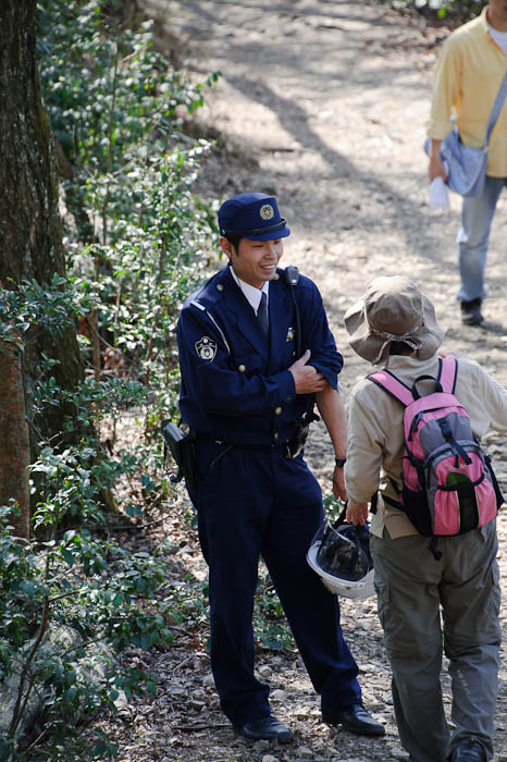 Not Your Average Hiker Kyoto Prefectural Policeman on the mountain above the fire pits -- Kyoto, Japan -- Copyright 2010 Jeffrey Friedl, http://regex.info/blog/