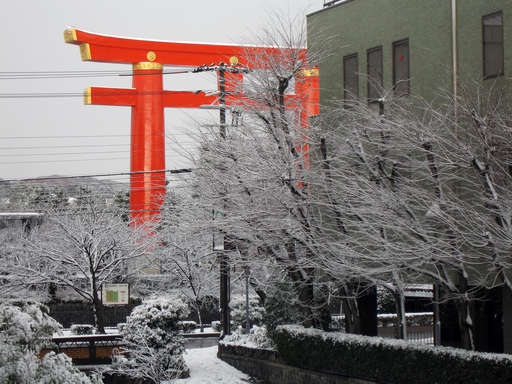 The main gate of the Heian Shrine (Kyoto Japan) shines during a break in the snow